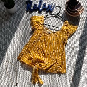 Cute little yellow, off the shoulder, floral top with tie at the bottom.